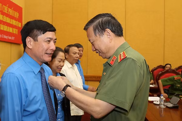 Bộ trưởng Tô Lâm gắn Kỷ niệm chương "Bảo vệ an ninh Tổ quốc" tặng Chủ tịch Tổng LĐLĐ Việt Nam Bùi Văn Cường.