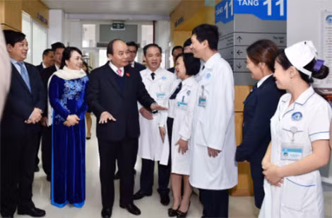 Thủ tướng thăm hỏi y, bác sĩ làm việc tại phòng khám. Ảnh: VGP/Nhật Bắc