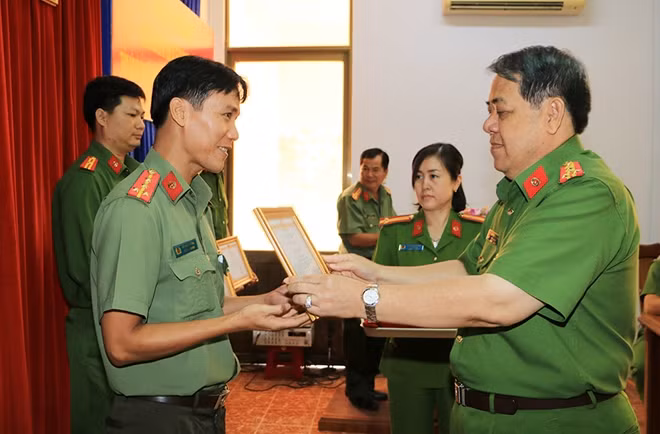 Đại tá Nguyễn Tấn Phước, Phó Giám đốc Công an tỉnh An Giang trao giấy khen của Giám đốc Công an tỉnh An Giang cho 12 CBCS.