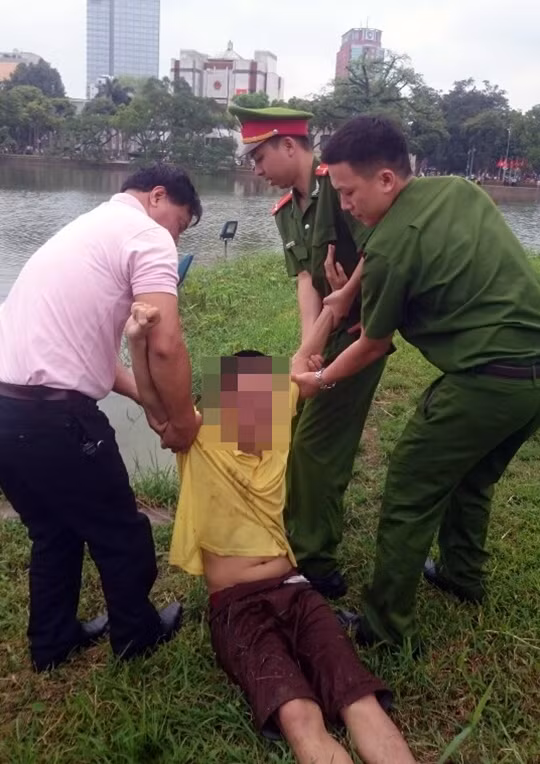 Nam thanh niên hùng hục bơi ra Tháp Rùa, luôn miệng lảm nhảm, hò hét.