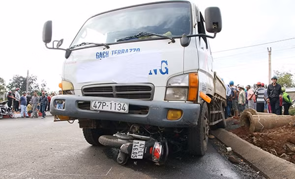 Chiếc xe máy bị xe tải kéo lê hàng chục mét.