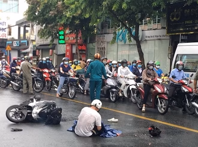 Người cha đau đớn ôm thi thể con gái trong mưa.
