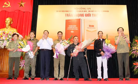 Các đại diện của Bộ Công an và Ban Dân vận TƯ tặng hoa đại diện những tấm gương tiêu biểu trong cuốn “Tỏa sáng giữa đời thường”.