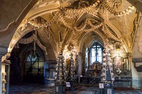 Nhìn bên ngoài, nhà thờ Sedlec Ossuary có dáng vẻ rất đỗi bình thường, song khung cảnh nội thất được kết bằng các hộp sọ, khúc xương người bên trong. Những đèn chùm lơ lửng hay các chi tiết trang trí trên tường, trần nhà, gian thờ... hẳn khiến nhiều người kinh hãi. Ảnh: Time Travel Turtle. Nhìn bên ngoài, nhà thờ Sedlec Ossuary có dáng vẻ rất đỗi bình thường, song khung cảnh nội thất được kết bằng các hộp sọ, khúc xương người bên trong. Những đèn chùm lơ lửng hay các chi tiết trang trí trên tường, trần nhà, gian thờ... hẳn khiến nhiều người kinh hãi. Ảnh: Time Travel Turtle.
