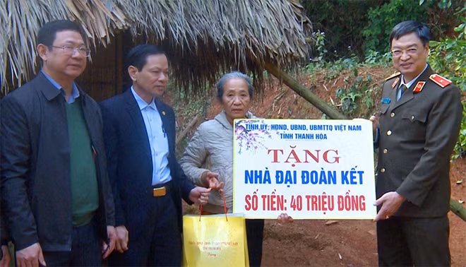 Đoàn công tác trao tiền hỗ trợ xây dựng Nhà Đại đoàn kết cho gia đình bà Bùi Thị Nhất.