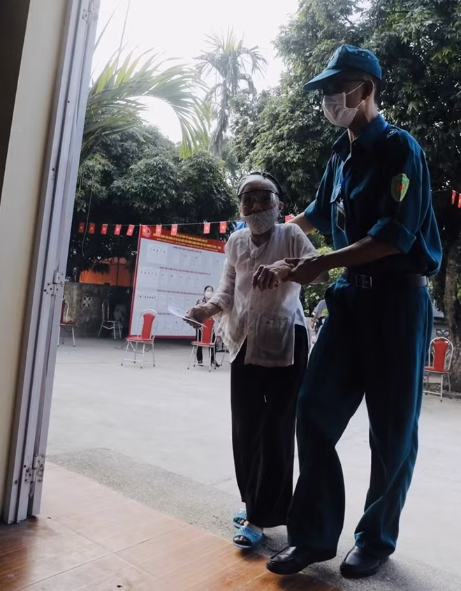 Các cử tri cao tuổi được giúp đỡ khi đi bầu cử tại điểm bầu cử xã Tự Nhiên, huyện Thường Tín, Hà Nội. (Ảnh: Trần Việt/TTXVN)