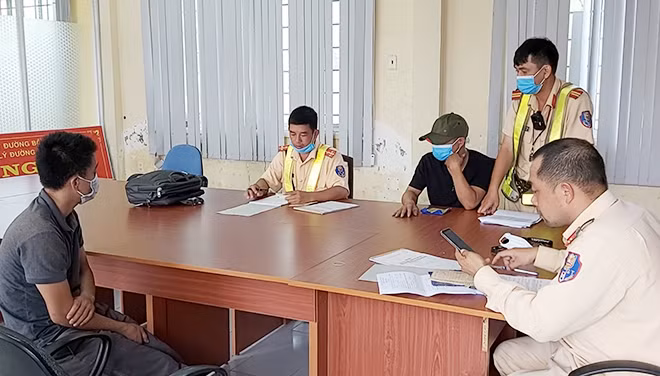 Tài xế Bá H. (người ngồi bên trái) và tài xế Huy H. đang làm việc với cơ quan chức năng.