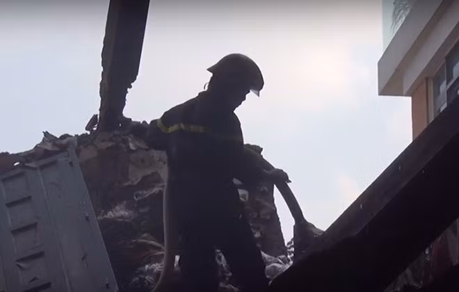Các chiến sĩ chữa cháy tiếp tục phun nước đề phòng ngọn lửa bùng phát trở lại