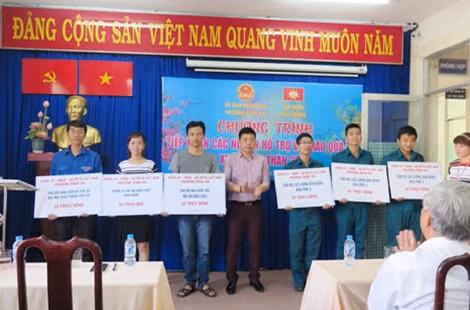 Ông Châu Thanh Hãn- Phó Tổng giám đốc Tập đoàn Phú Cường chụp hình lưu niệm với các hộ dân được tặng quà.