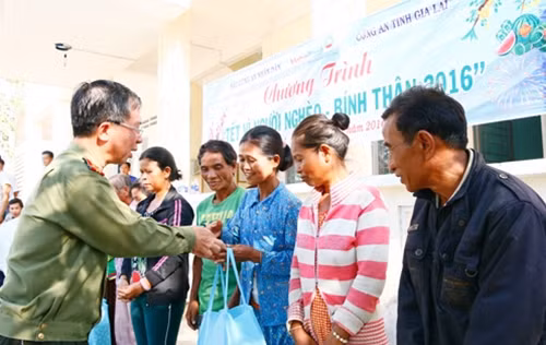 Đại tá Đặng Văn Lân, Phó Tổng biên tập Báo CAND trao quà Tết tặng bà con nghèo tỉnh Gia Lai.