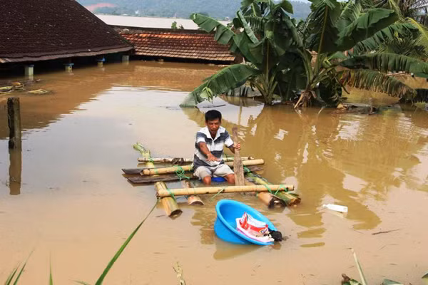 Nước lũ dâng cao ngập tới nóc nhà, người dân kết chuối làm bè để di chuyển. (Ảnh: Ban Phòng chống lụt bão tỉnh Thừa Thiên Huế).