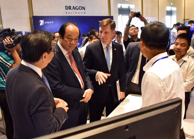 Bộ trưởng, Chủ nhiệm Văn phòng Chính phủ Mai Tiến Dũng trao đổi với các đại biểu bên hành lang Hội thảo.