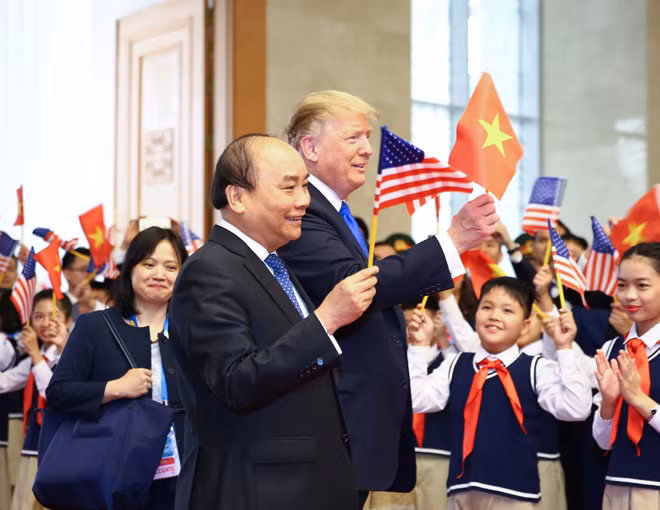 Hình ảnh Thủ tướng Nguyễn Xuân Phúc vẫy cờ Mỹ và Tổng thống Donald Trump vẫy cờ Việt Nam cạnh các em thiếu nhi sáng 27-2 tại trụ sở Chính phủ gây sốt trên truyền thông.