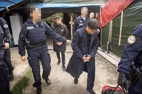 Người Việt nhập cư lậu được đưa đi trong một lần đột kích ở Calais. Ảnh: Le Figaro.