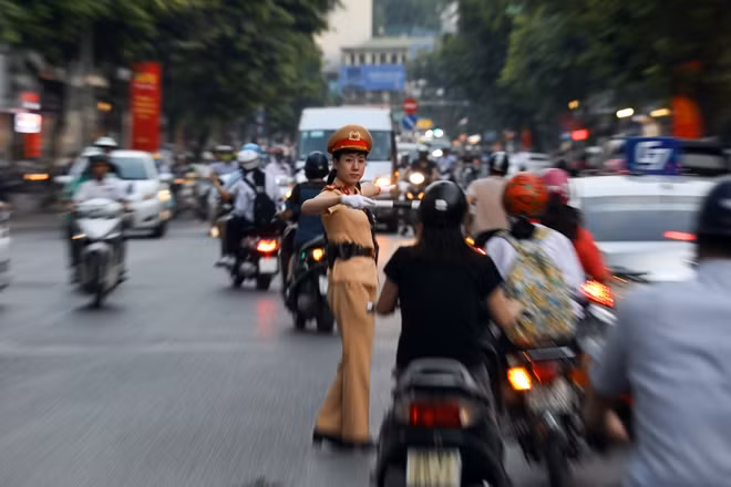 Thượng úy Nguyễn Mai Huyền như con thoi điều tiết giao thông tại ngã tư Trần Phú - Điện Biên Phủ giữa dòng phương tiện đông đúc của giờ cao điểm.