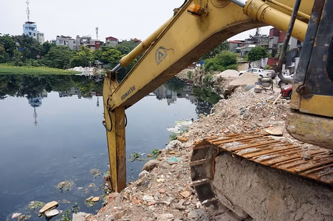 Ghi nhận tại hiện trường, các hoạt động thi công mới dừng lại ở việc hút nước khỏi lòng hồ và đổ các khối bê tông cho việc kè bờ sau này.