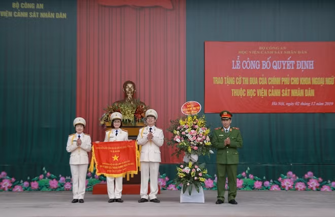 Thiếu tướng, GS.TS Trần Minh Hưởng, Giám đốc Học viện trao Cờ thi đua của Chính phủ cho tập thể lãnh đạo Khoa Ngoại ngữ.