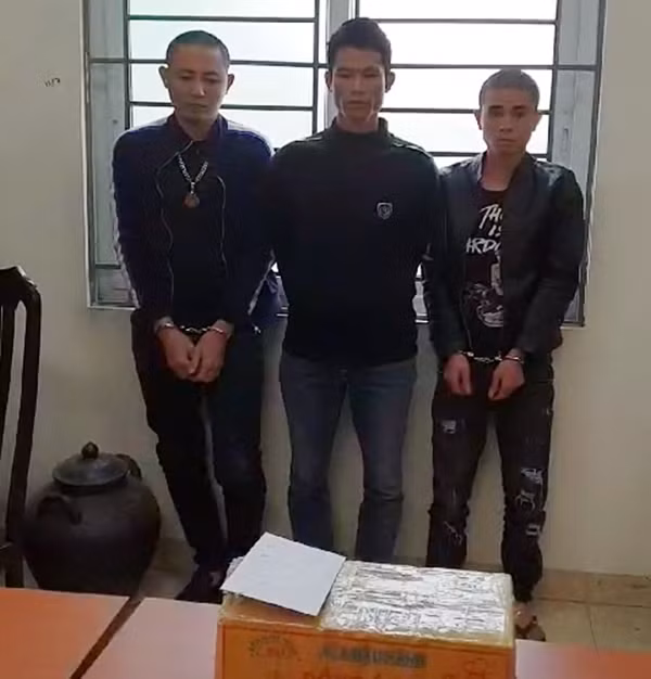 Đối tượng Dương Văn Tuấn (ngoài cùng bên trái) cùng hai đối tượng liên quan và tang vật tại cơ quan Công an.