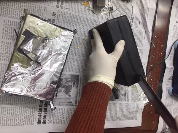 Cơ quan Công an lấy mẫu vật chứng ma túy khi thu giữ 50 bánh heroin. Cơ quan Công an lấy mẫu vật chứng ma túy khi thu giữ 50 bánh heroin.
