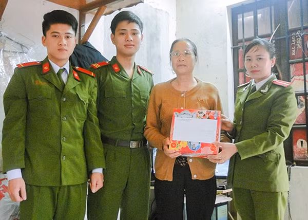 Trung úy Nguyễn Thị Thanh thăm hỏi, tặng quà một gia đình có hoàn cảnh khó khăn.