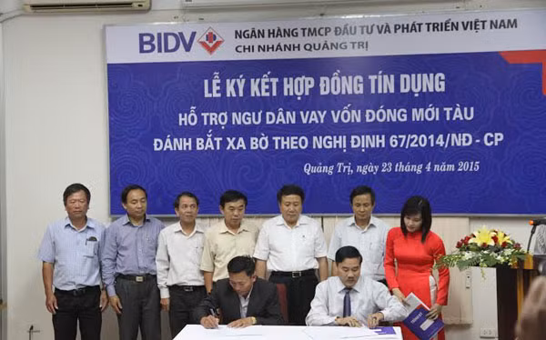 Đại diện BIDV Quảng Trị ký kết và trao tiền cho ngư dân. Ảnh: Phuongnam.net.