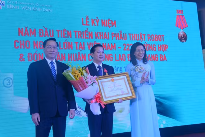 Bà Nguyễn Thị Thu, Phó Chủ tịch UBND TP HCM thừa ủy quyền của Chủ tịch nước, trao Huân chương Lao động hạng Ba cho cá nhân bác sĩ Trần Vĩnh Hưng.