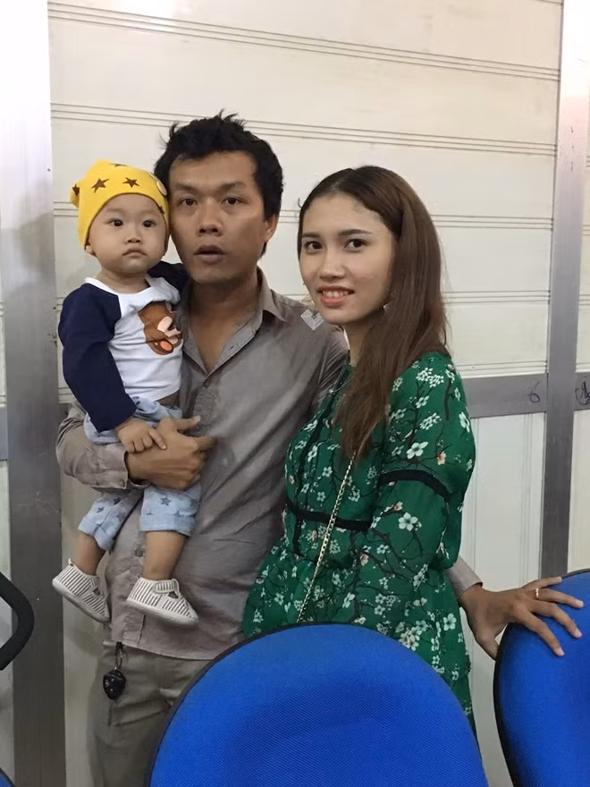 Bệnh nhân Nguyễn Cẩm Nhường bên cạnh vợ và cậu con trai 11 tháng trong buổi tiếp xúc báo chí chiều 1-3.