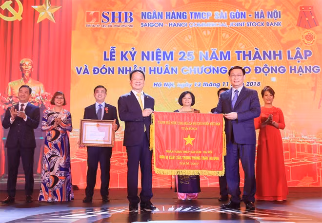 Phó Thủ tướng Chính phủ Vương Đình Huệ thay mặt Đảng và Nhà nước trao Huân chương Lao động Hạng Nhì và Cơ Thi đua của Chính phủ cho Ngân hàng SHB vì đã hoàn thành xuất sắc, toàn diện nhiệm vụ công tác, dẫn đầu phong trào thi đua năm 2017 của ngành ngân hàng. Phó Thủ tướng Chính phủ Vương Đình Huệ thay mặt Đảng và Nhà nước trao Huân chương Lao động Hạng Nhì và Cơ Thi đua của Chính phủ cho Ngân hàng SHB vì đã hoàn thành xuất sắc, toàn diện nhiệm vụ công tác, dẫn đầu phong trào thi đua năm 2017 của ngành ngân hàng.