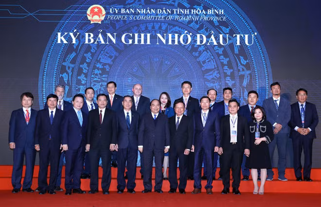 Thủ tướng Nguyễn Xuân Phúc và đại diện các doanh nghiệp có kế hoạch đầu tư vào tỉnh Hoà Bình. Ảnh: TTXVN.