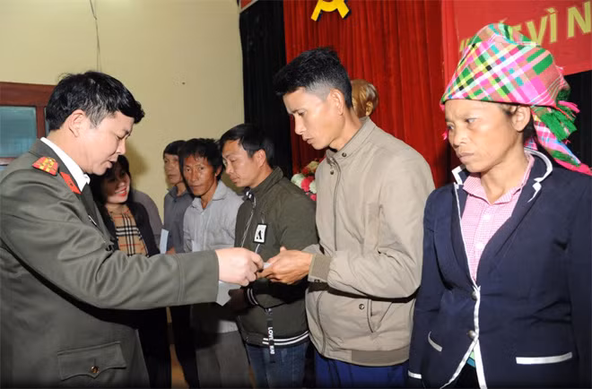Thượng tá Tạ Phúc Rực, Trưởng phòng Công tác Chính trị - Công an tỉnh Lai Châu trao quà Tết tới đồng bào nghèo xã Trung Đồng.